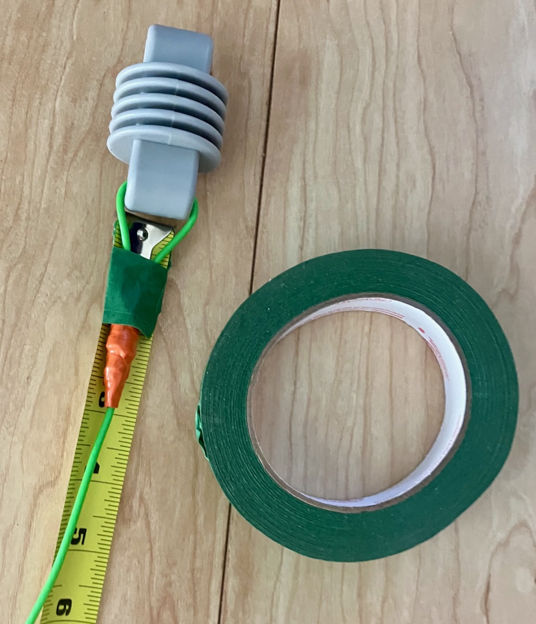 wire taped to measuring tape with painters tape